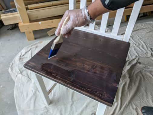 A coat of polyurethane was applied with a brush to the top and sides of the seat.