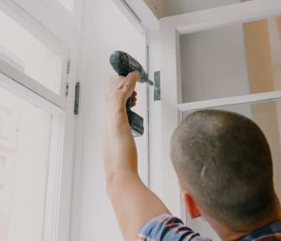 If the door is sticking to the frame due to loose screws holding the hinge, the solution is to simply tighten the screws using a screwdriver, power drill, or impact driver.
