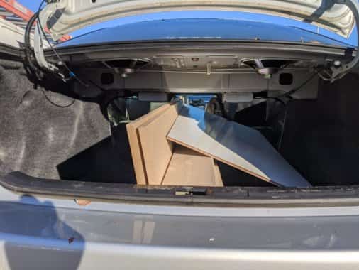 I used one of our family sedans to carry all supplies for this project. Shown here are the boards for the project, including the 8ft MDF boards and 2'x4' marker boards, as seen through the trunk of our Toyota Corolla.